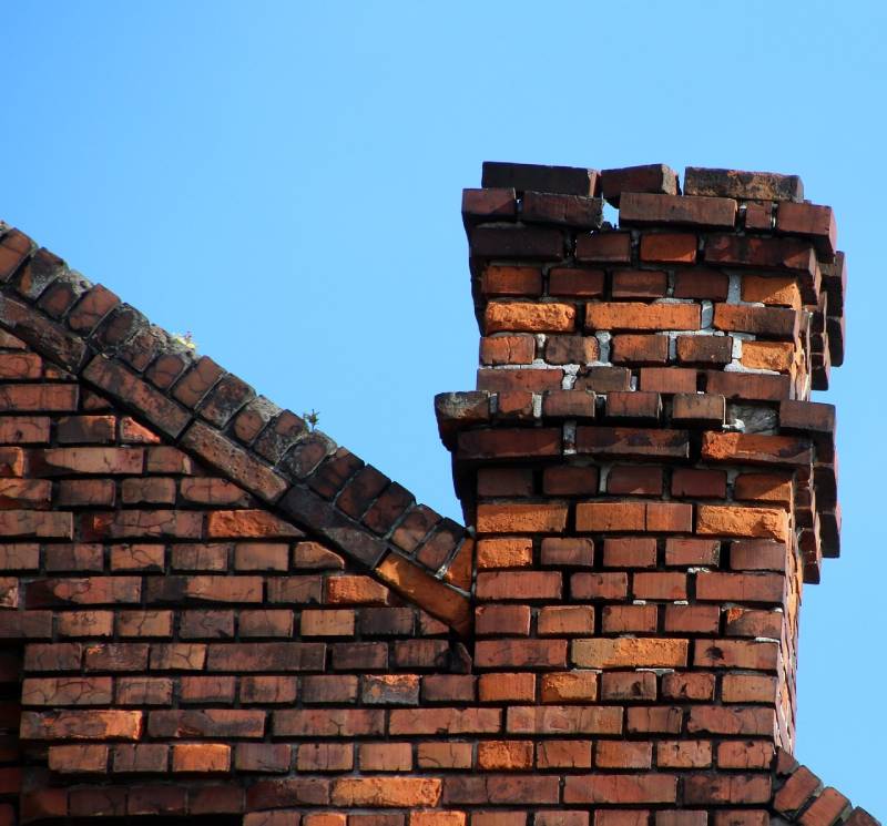Signs Your Opa-Locka Home Needs a Chimney Inspection Damaged chimney on an Opa-Locka home showing cracks and missing mortar